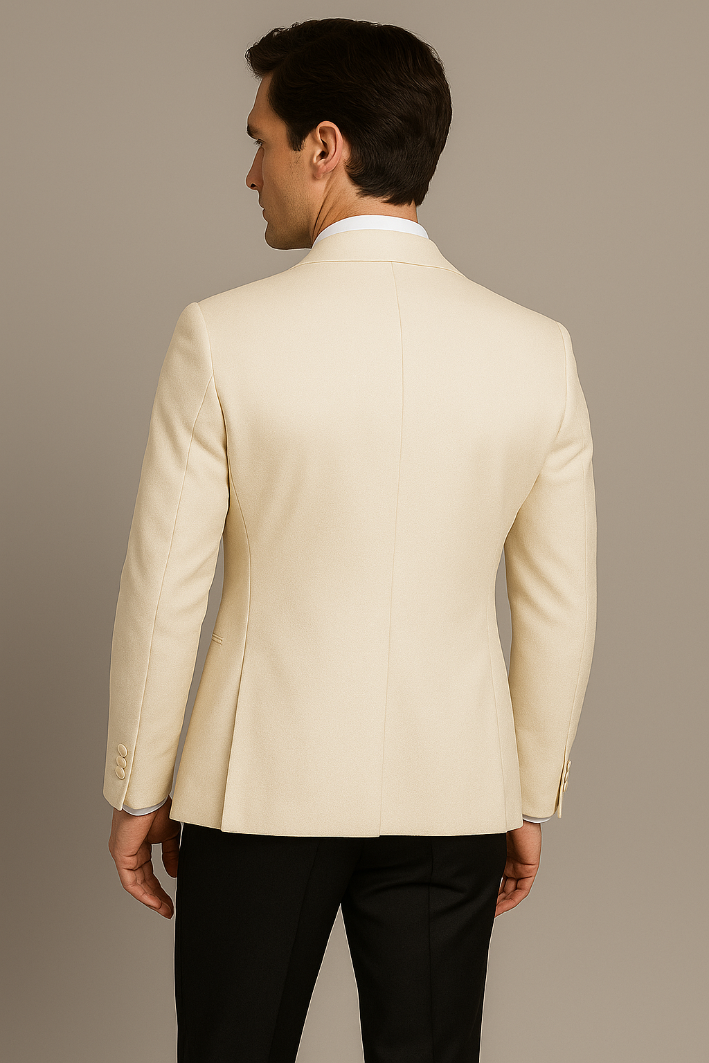 Man wearing a beige suit jacket on a plain background