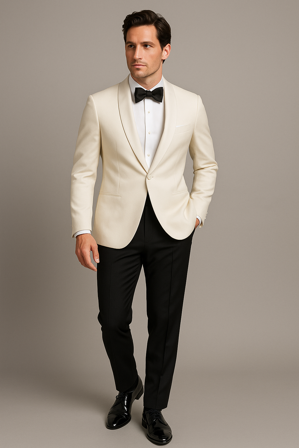 Man wearing a white tuxedo with black bow tie and pants on a plain background